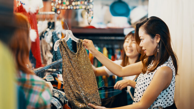 Two female friends shopping in a vintage clothing store in Japan