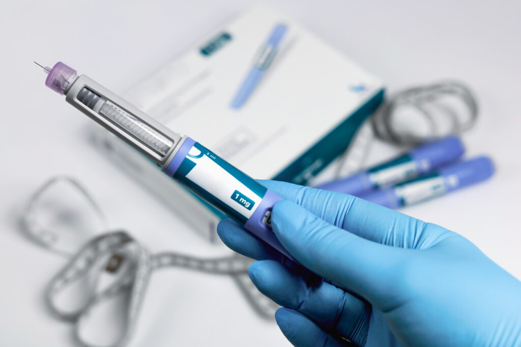 Hands in blue surgical gloves holding Ozempic Insulin injection pen for diabetics. Ozempic in Japan