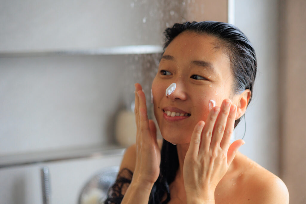 Woman cleansing face with foam sud